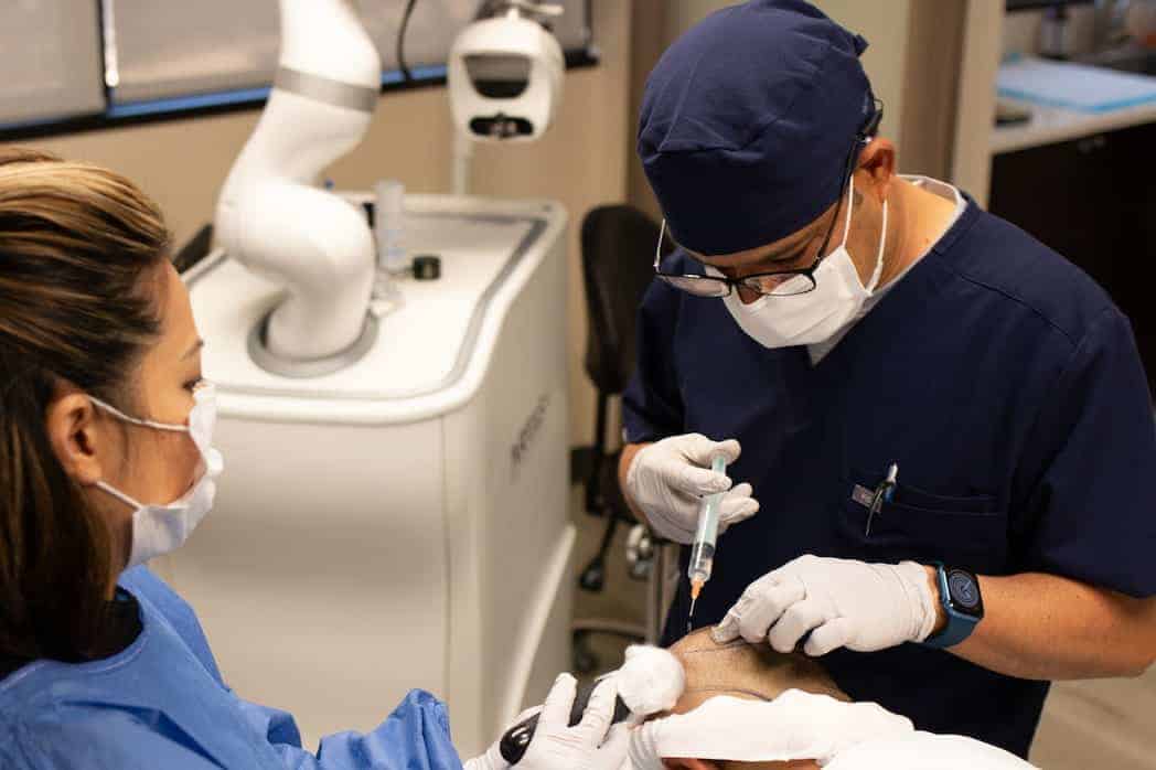 Austin-Hair-Restoration-Clinic-Dr-FUE-Procedure-1 Dr Dubey performing a procedure on a patient